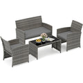 Ensemble de jardin quatre pieces avec structure en resine tressee et table basse en verre trempe