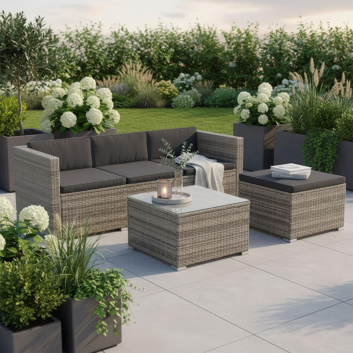 Salon exterieur en polyrotin avec canape trois places, table, tabouret et coussins pour quatre personnes