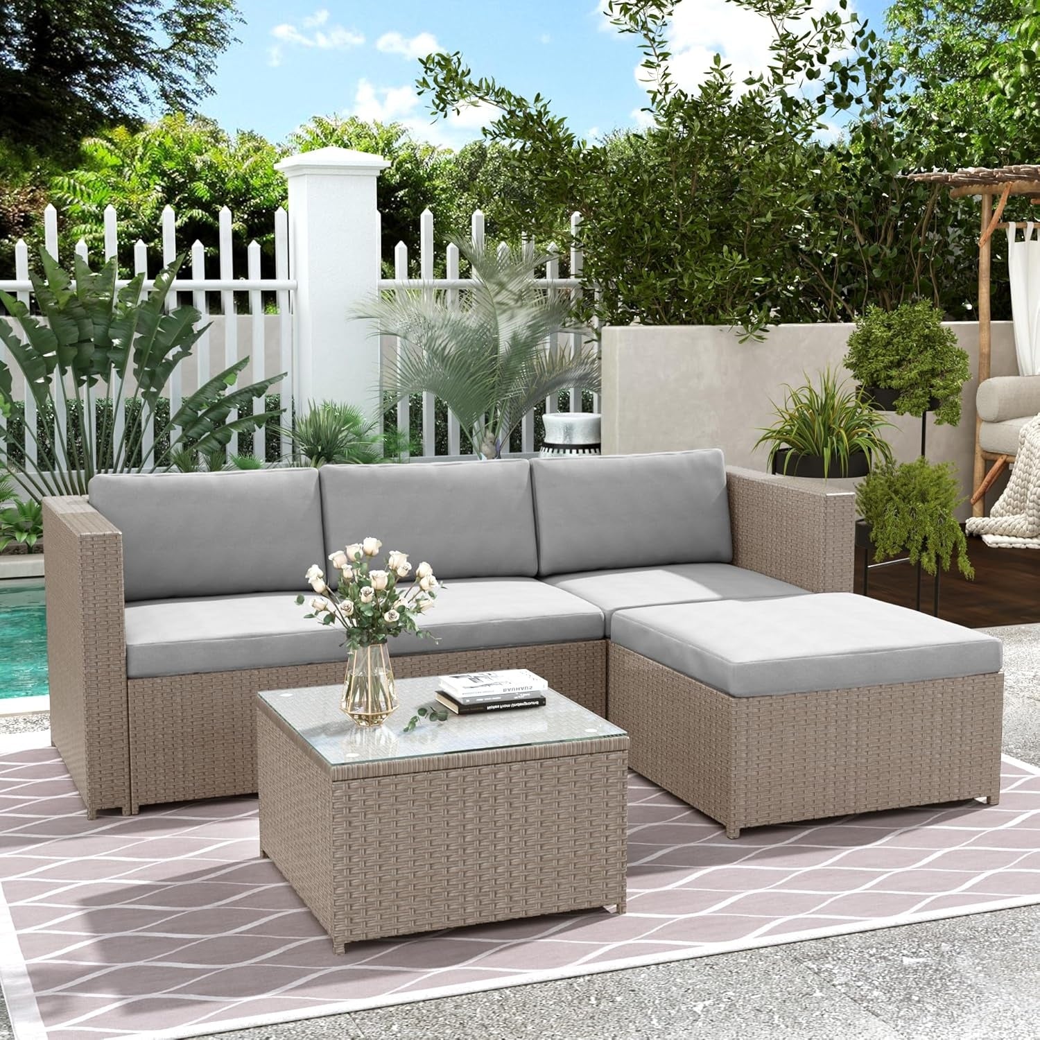 Salon de jardin en resine tressee avec coussins et table en verre pour trois a quatre personnes